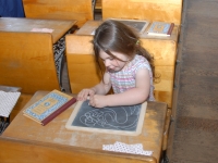 A young girl, studying in school
