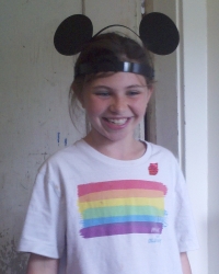 Sara in her pride shirt and mouse ears